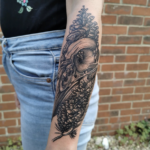 Crow skull with pine cones tattoo